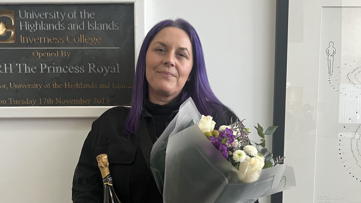 Student Nadine Murray with flowers