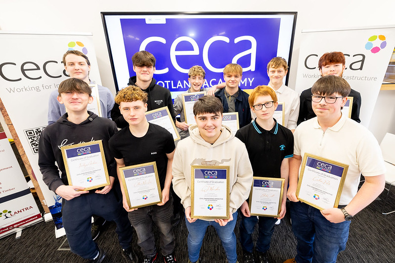 a group of students holding up certificates
