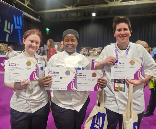 Sydney, Blessing and Stevie holding their certificates and medals at the event in Glasgow