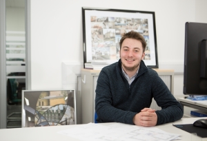 Jordan McNeilage sitting at his desk