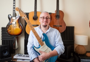 Jacob Hodge holding a guitar