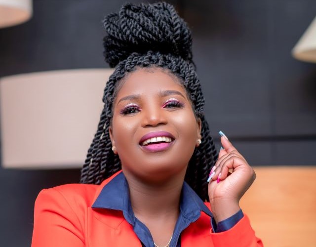 Winnie Mwongela in bright orange jacket