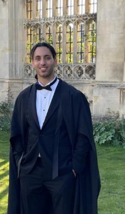 Man wearing a tuxedo and graduation gown. Man wearing a tuxedo and graduation gown.