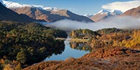 mountains in distance, loch at fore of image